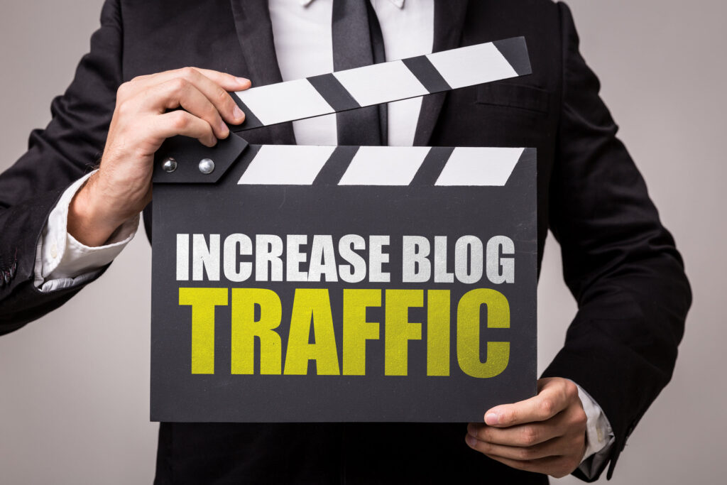 man in business suit holding sign that says "increase blog traffic"