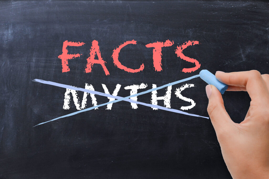 "facts" written above crossed-out "myths" on chalkboard