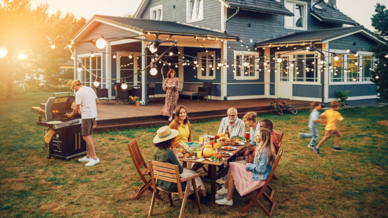 A family enjoying a BBQ in their backyard.