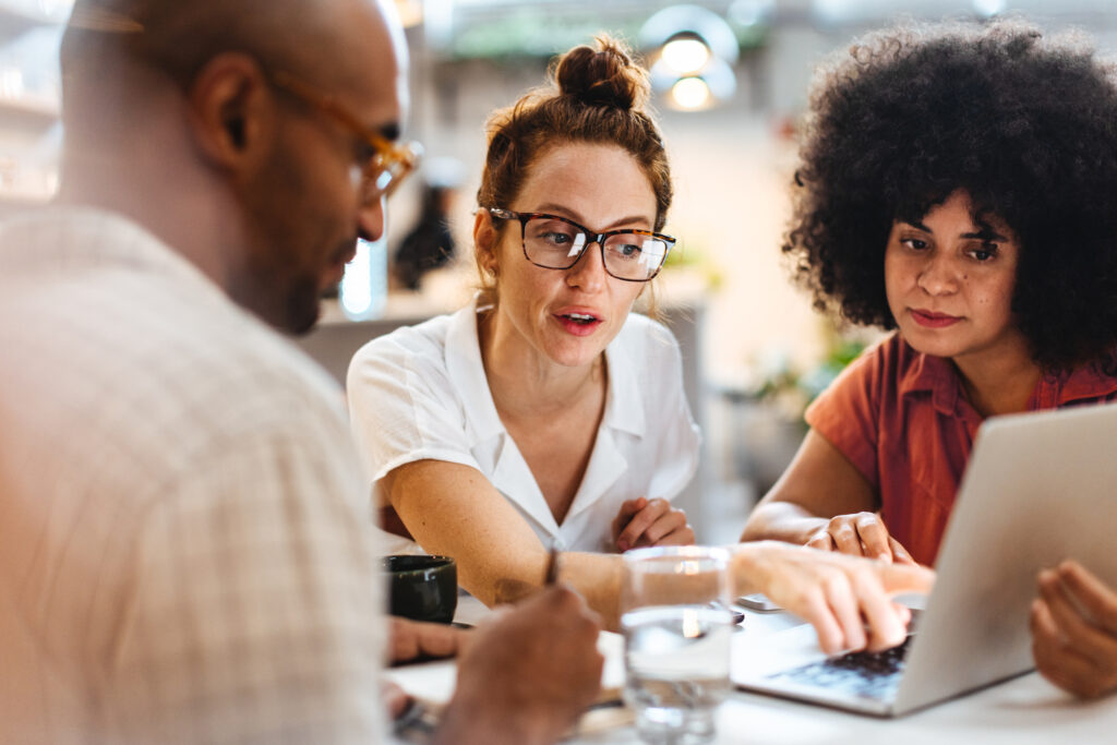 Business women having a discussion with a client over a business lunch