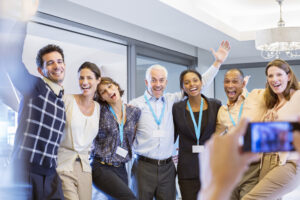 Business people taking photograph together