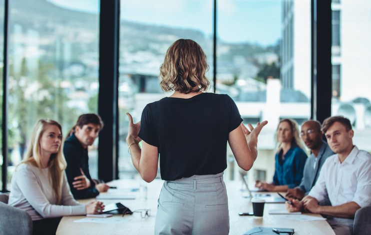 Business woman speaking to room